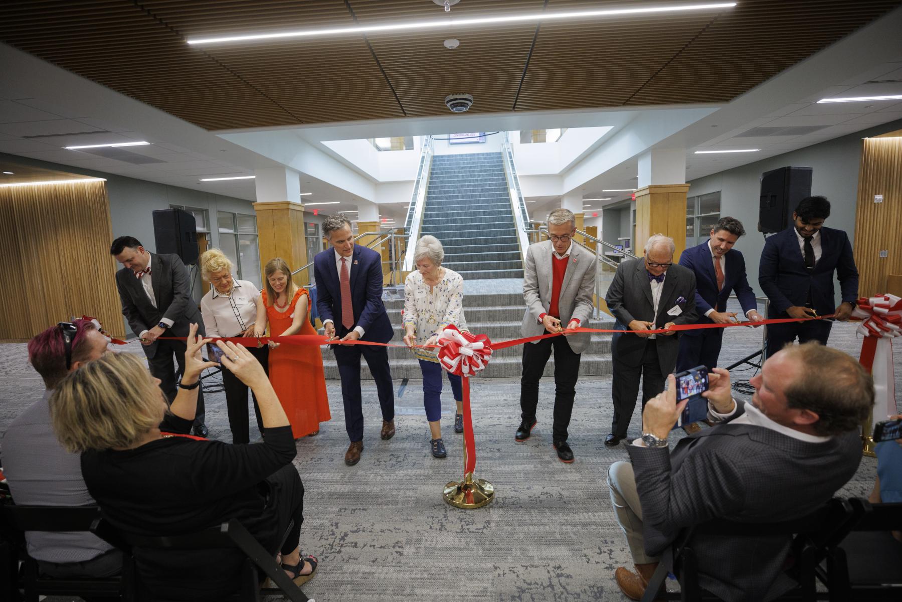 Ribbon cutting at the grand re-opening for the Schmid Law Library