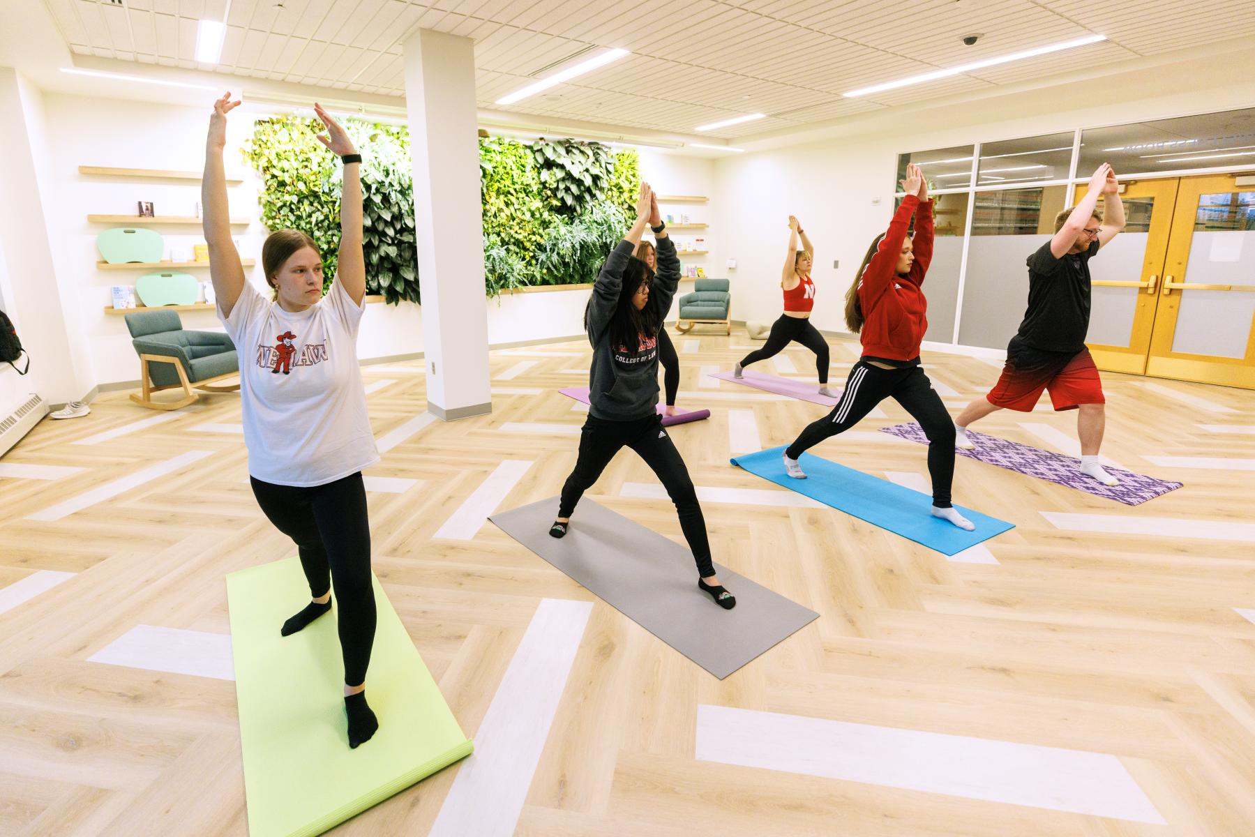 Students do yoga in the wellness room at the College of Law