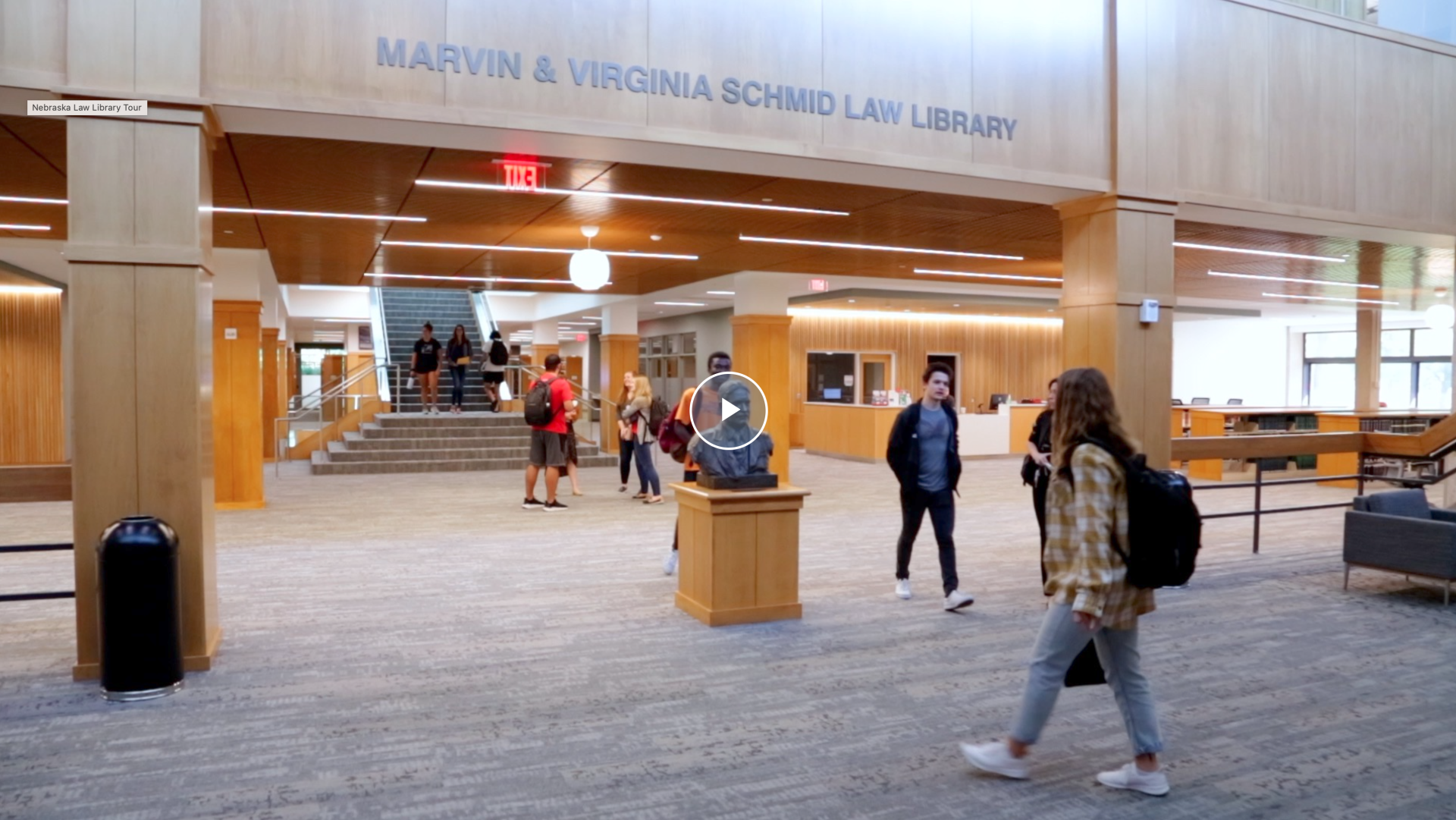 Videos screenshot of students walking through the library lobby