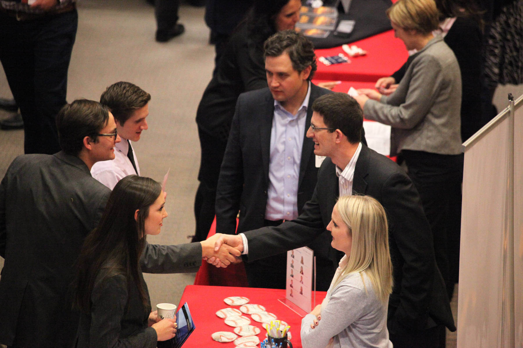 Alumni shaking hands at event
