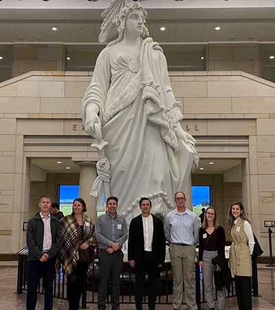 Students stand in front of a model of the Statue of Freedom in Emancipation Hall