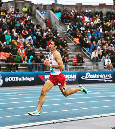 Cortez Ruiz, '24, runs on a track.