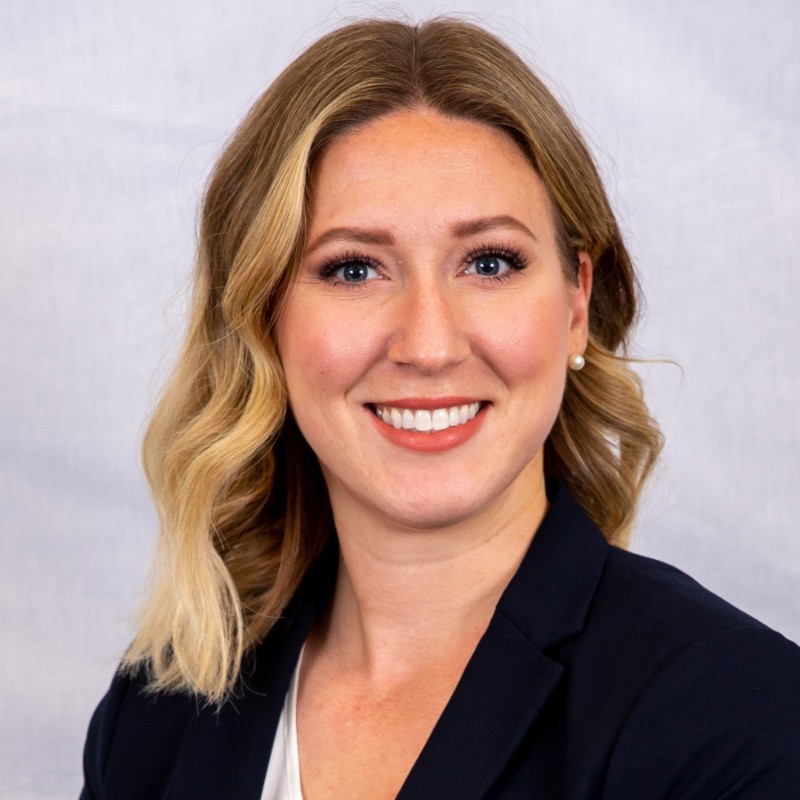 Headshot of Kalie, who is wearing a black suit jacket and has long blonde hair