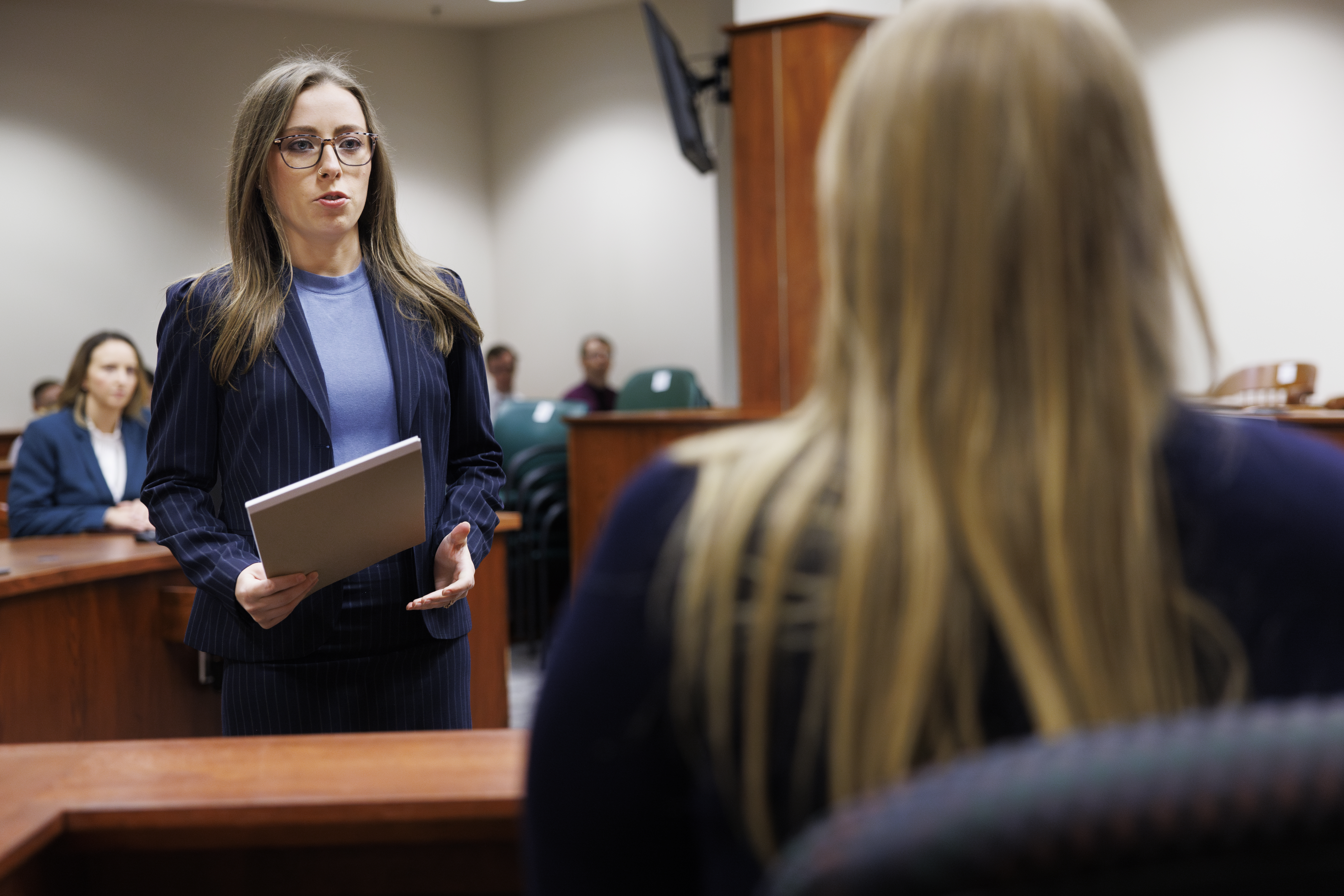Student attorney speaking to witness in courtroom