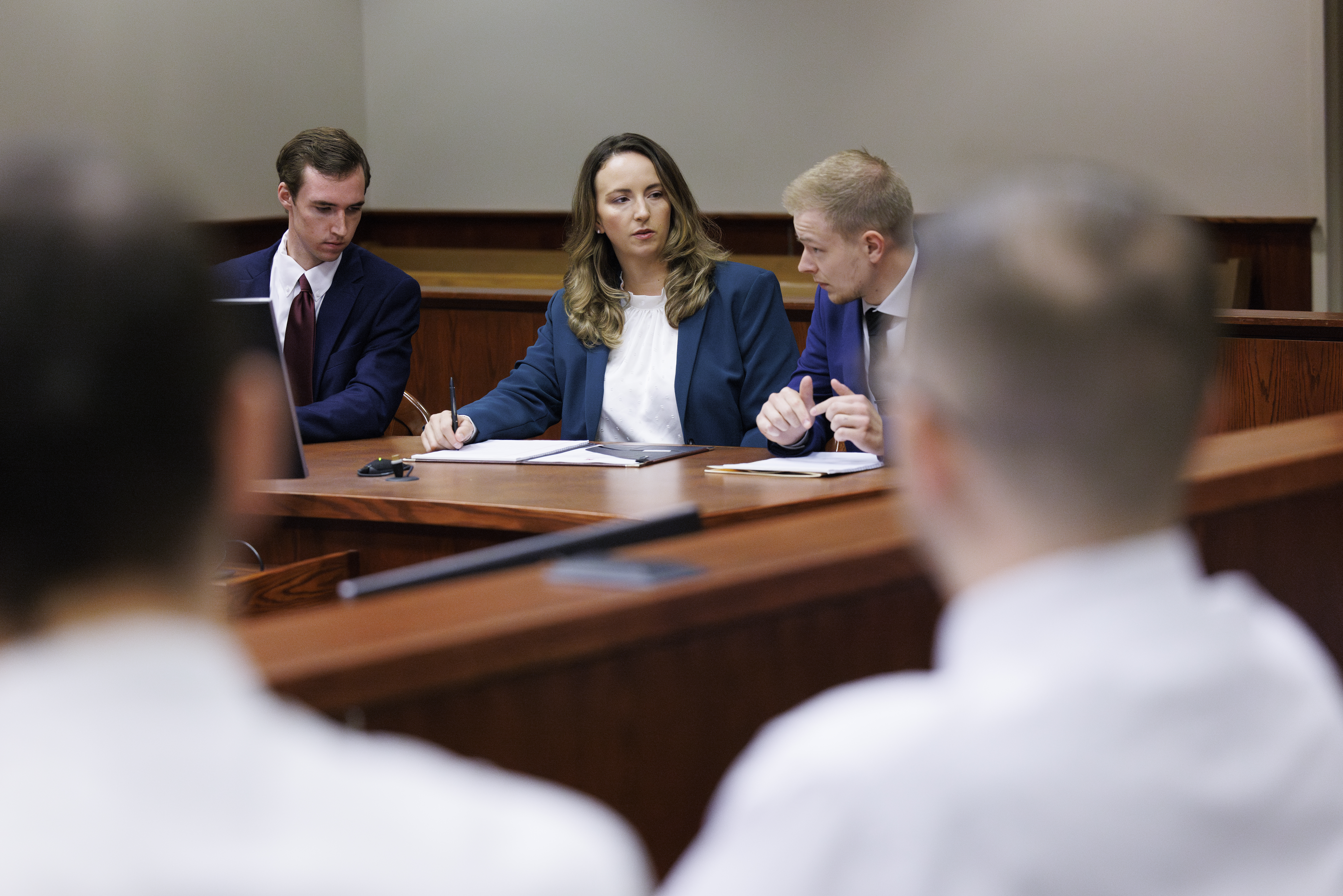 Students sitting with Professor in courtroom