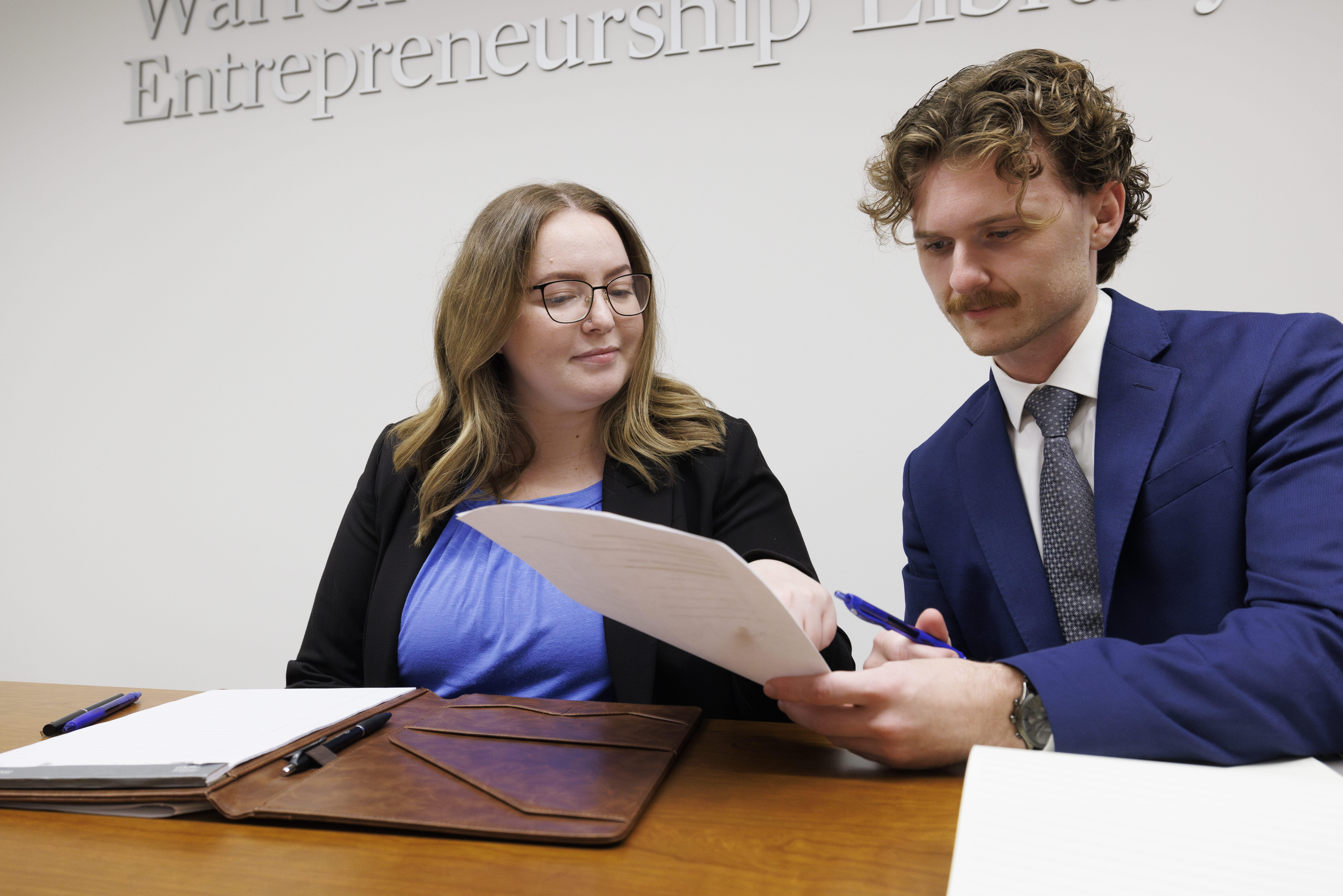 Two student attorneys reviewing a document