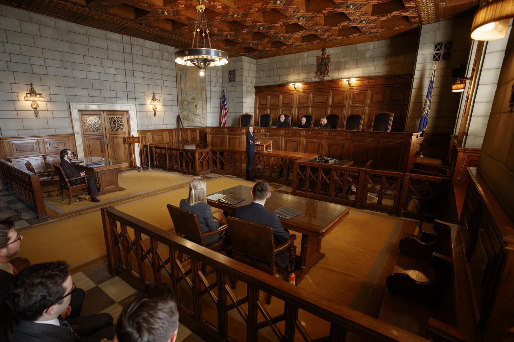 Courtroom showing judges and prosecution and defendant tables