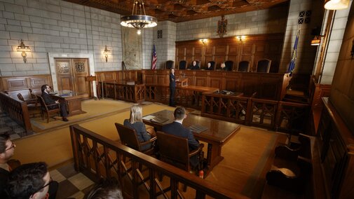 Courtroom showing judges and prosecution and defendant tables
