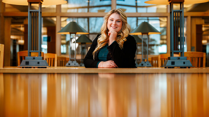 Delaney Doyle poses for a photo in the Marvin & Virginia Schmid Law Library