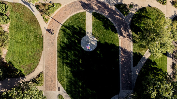 Morning sunlight greets a cyclist as they ride across the East Campus Mall on Oct. 10.