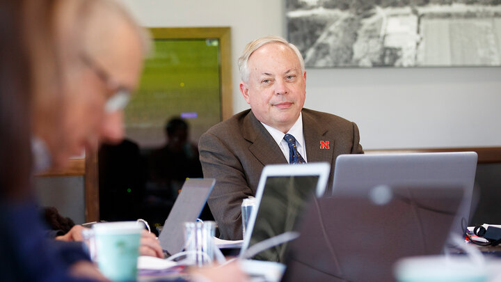 Jack Beard sitting at a table with laptop in front of him with others around him doing the same