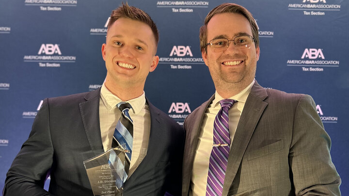 Andrew Harker and Nolan Schafer stand with their awards