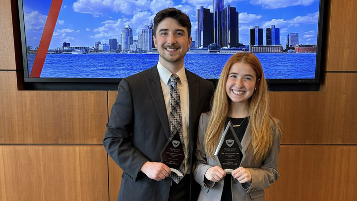Hannah-Kate Kinney and Jack Kinney standing and posing with their trophies