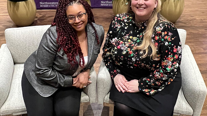 two female students sitting in chairs