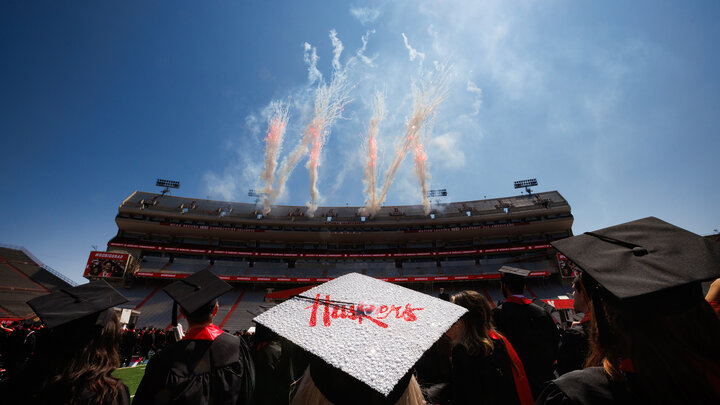 Students watching commencement in Memorial Stadium