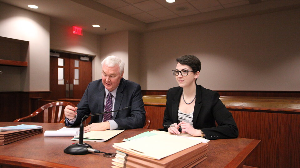 Student and instructor at court table