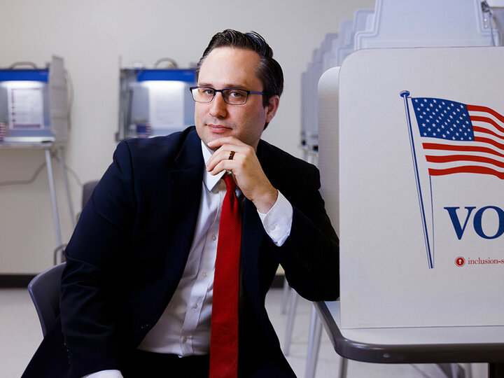 Brandon Johnson sitting at a voting booth