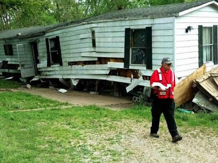 Person walking outside abandoned run-down mobile home