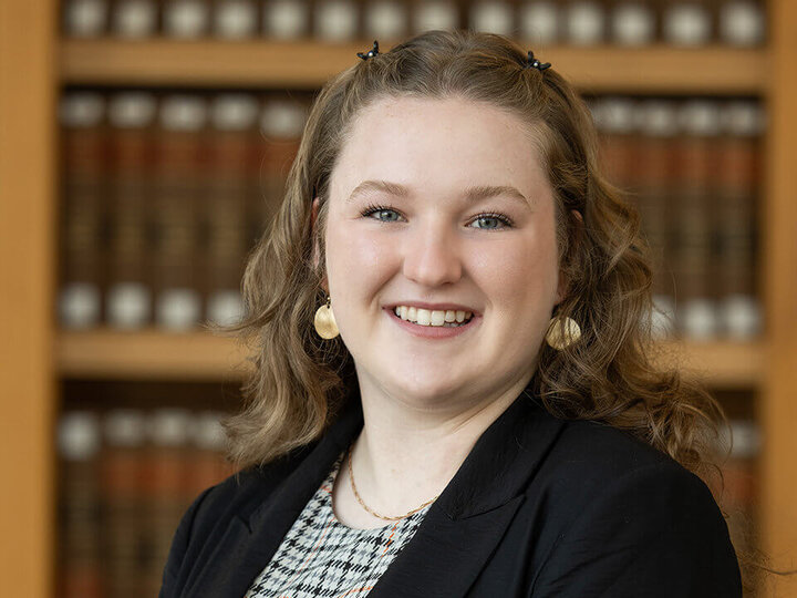 Portrait of Olivia Neddermeyer with books in background