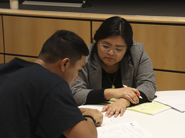 A clinic student is reviewing paperwork with a potential client