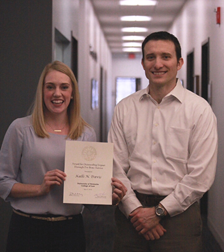 Kalli Davis holding Pro Bono Award with Ryan Sullivan