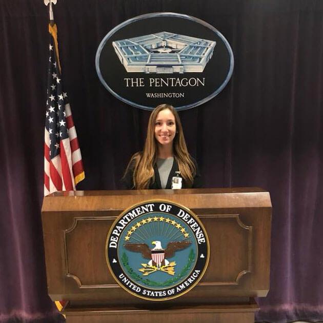 Nichole standing at podium in The Pentagon