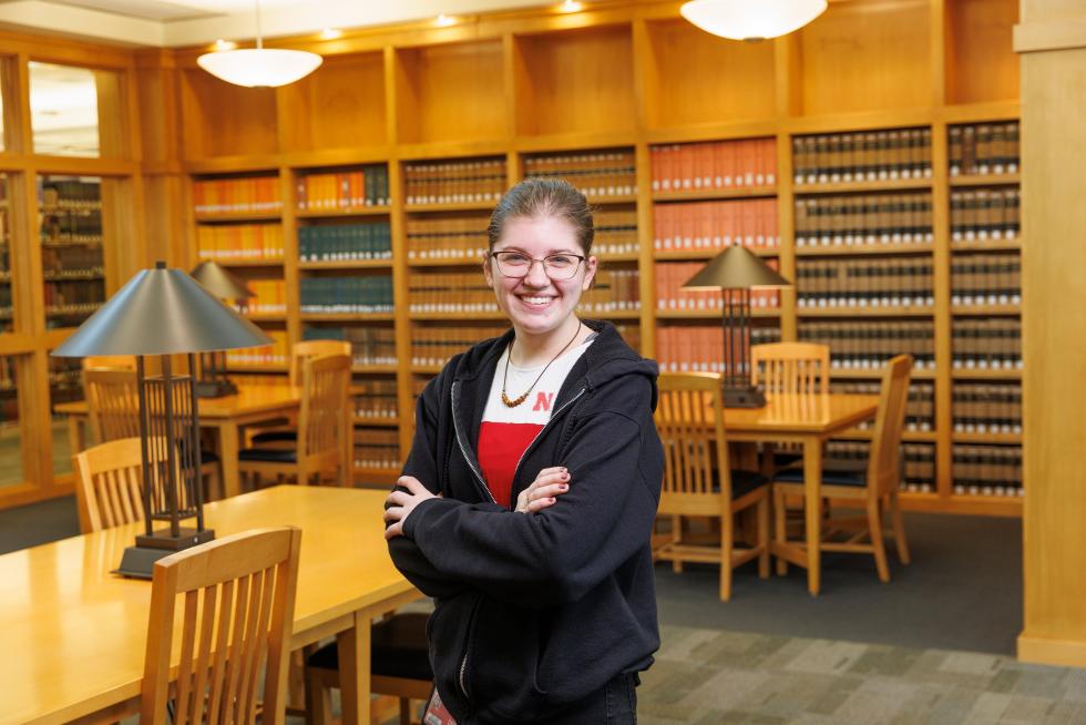 Ashlee McGill standing in front of bookshelves