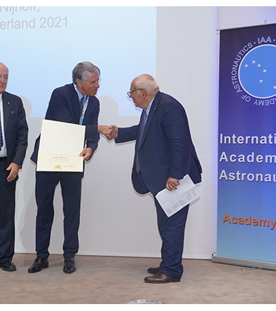 Professor Frans von der Dunk shakes hands with the award presenter at the IAC Awards Banquet.