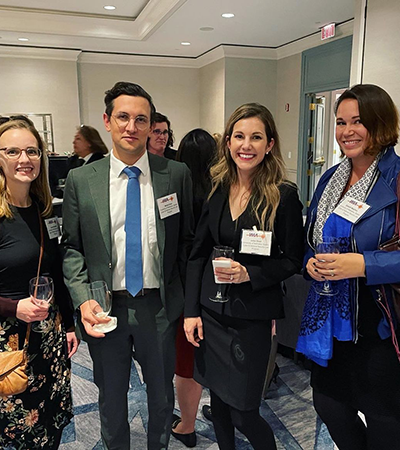 A photo of Associate Director Lauren Bydalek, JD student Matias Cava, LLM student Jill Sloan, and Executive Director Elsbeth Magilton take a photo together at the event.
